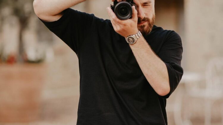 Documentary-style wedding videographer filming outdoor portraits