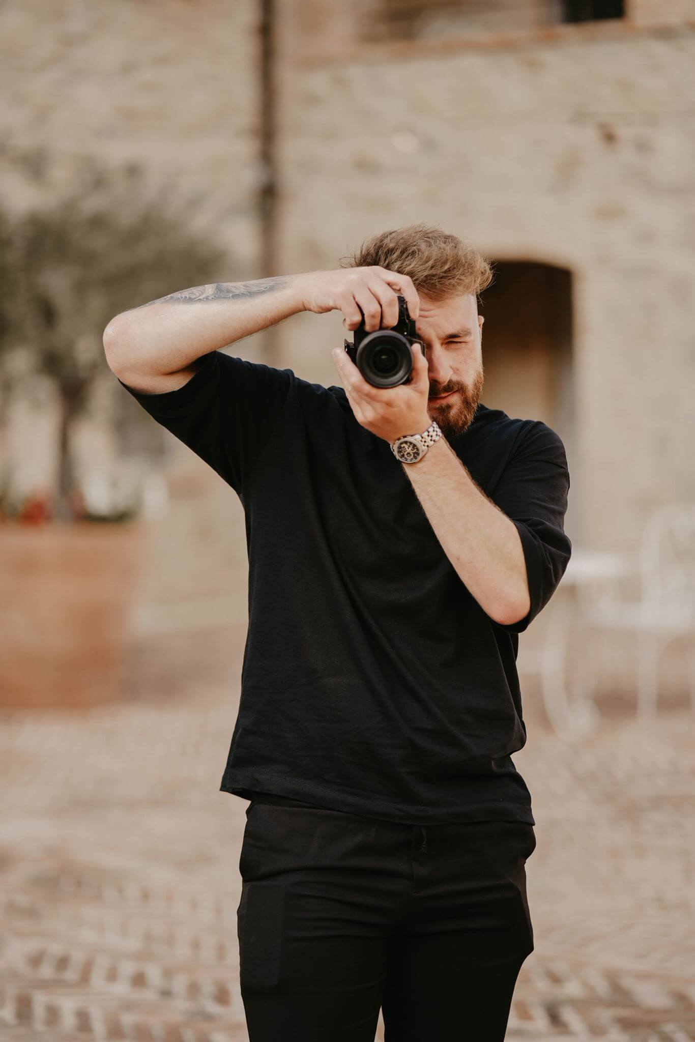 Documentary-style wedding videographer filming outdoor portraits