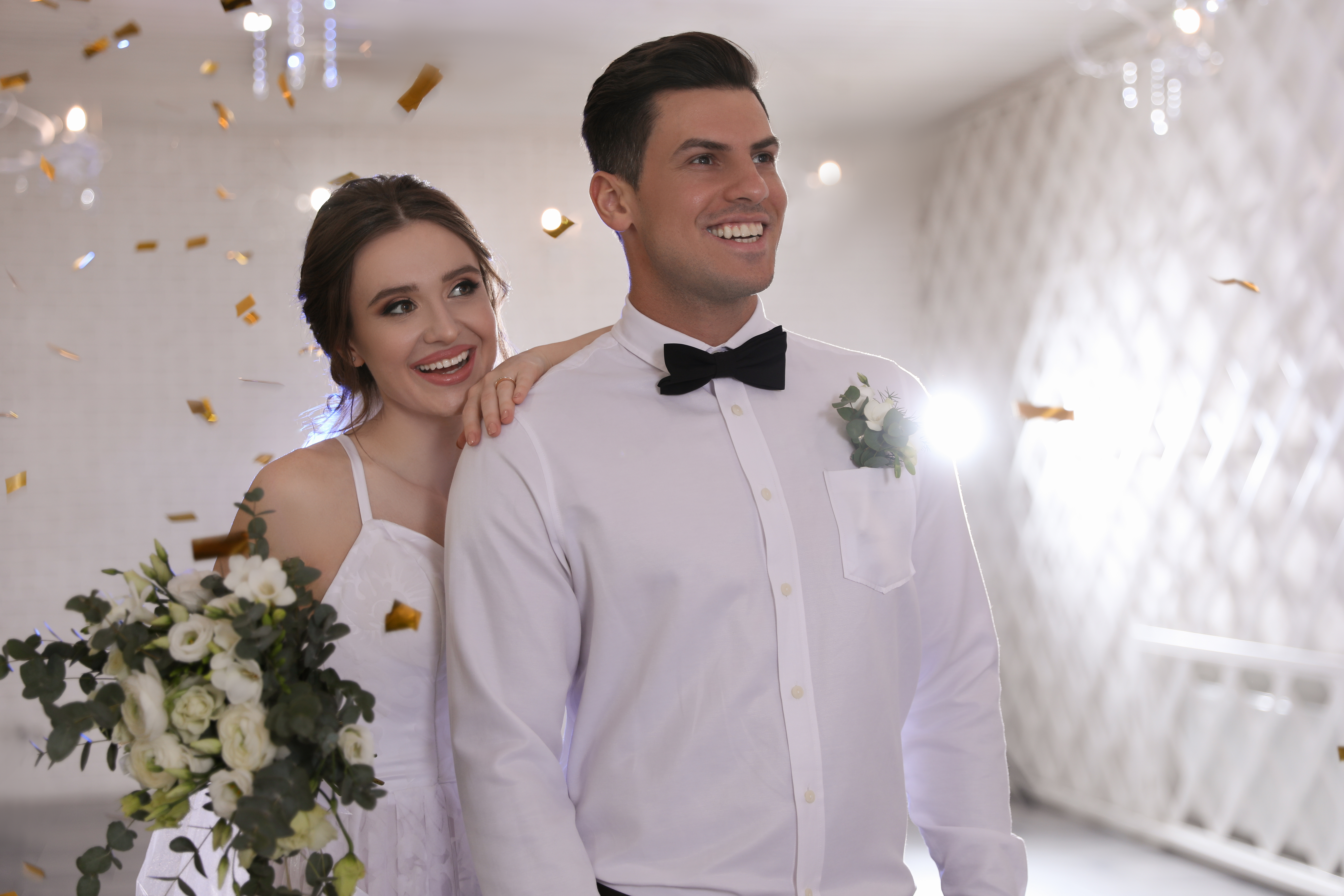 Happy newlywed couple together in festive hall